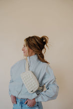 Load image into Gallery viewer, side view of model wearing the cherish the moment jacket in the color misty grey. model has the jacket paired with the never hesitate top in the color black, the no rules belt bag in beige, and the charleston denim.