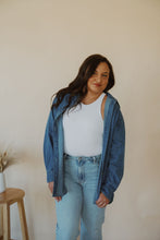 Load image into Gallery viewer, front view of model wearing the denim daze top. model has the top paired with the change your mind bodysuit in the color white and the charleston denim.