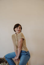 Load image into Gallery viewer, side view of model wearing the nothing to prove top in the color oat. model has the top paired with thistle + elm&#39;s aurora denim.