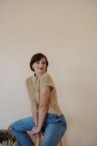 side view of model wearing the nothing to prove top in the color oat. model has the top paired with thistle + elm's aurora denim.