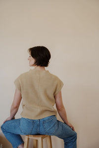back view of model wearing the nothing to prove top in the color oat. model has the top paired with thistle + elm's aurora denim.