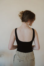 Load image into Gallery viewer, back view of model wearing the used to know bodysuit in the color black. model has the bodysuit paired with the in another life skirt.