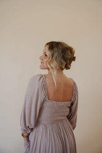 close up back view of model wearing the all my love maxi dress in the color taupe.