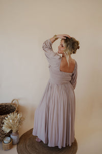 back view of model wearing the all my love maxi dress in the color taupe.