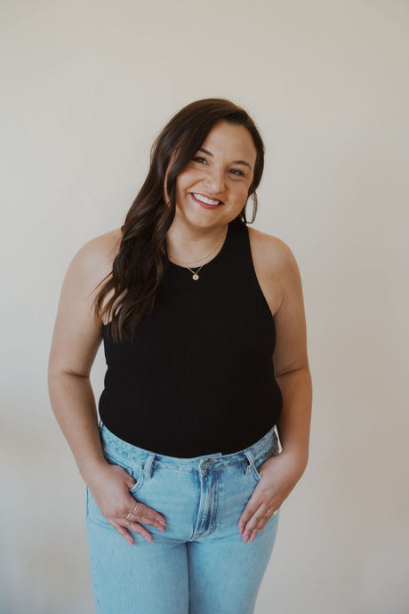 front view of model wearing the change your mind bodysuit in the color black. model has the bodysuit paired with the charleston denim.