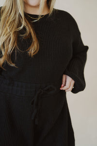 detail view of model wearing the wouldn't change a thing romper in the color black.