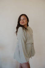 Load image into Gallery viewer, side view of model wearing the wouldn&#39;t change a thing romper in the color taupe.