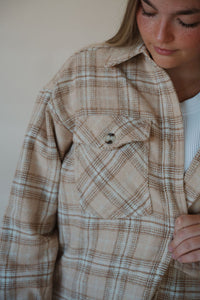 detail view of model wearing the make things right shacket. model has the shacket paired with the forever yours tank in the color white and the genevive denim.