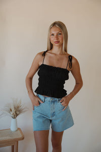front view of model wearing the so surreal top. model has the top paired with the dakota denim shorts.
