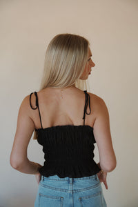 back view of model wearing the so surreal top. model has the top paired with the dakota denim shorts.