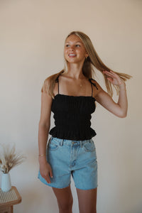 front view of model wearing the so surreal top. model has the top paired with the dakota denim shorts.