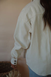 detail view of model wearing the all this time shacket. model has the shacket paired with the forever yours top in the color macchiato and the charleston denim.