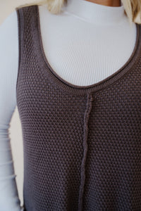 close up view of the never let me go jumpsuit in the color chocolate paired with the all along top in the color white.