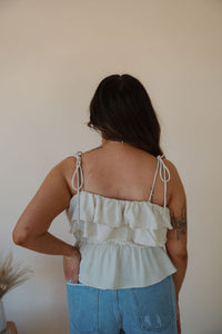 back view of model wearing the by the shore top. model has the top paired with the boston denim shorts.