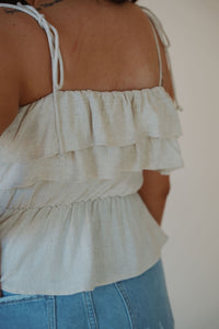 detail view of model wearing the by the shore top. model has the top paired with the boston denim shorts.