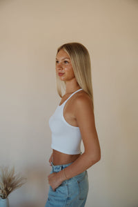 side view of model wearing the these days top in the color white. model has the top paired with the dakota denim shorts.