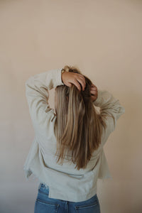 back view of model wearing the only just begun jacket in the color beige. model has the jacket paired with the aurora denim.