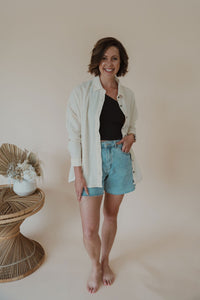 front view of model wearing the rising tide top. model has the top paired with the last to know top in the color black and the dakota denim shorts.