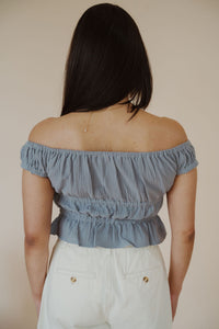 back view of model wearing the dream on top. model has the top paired with the sweetest melody shorts in the color cream.