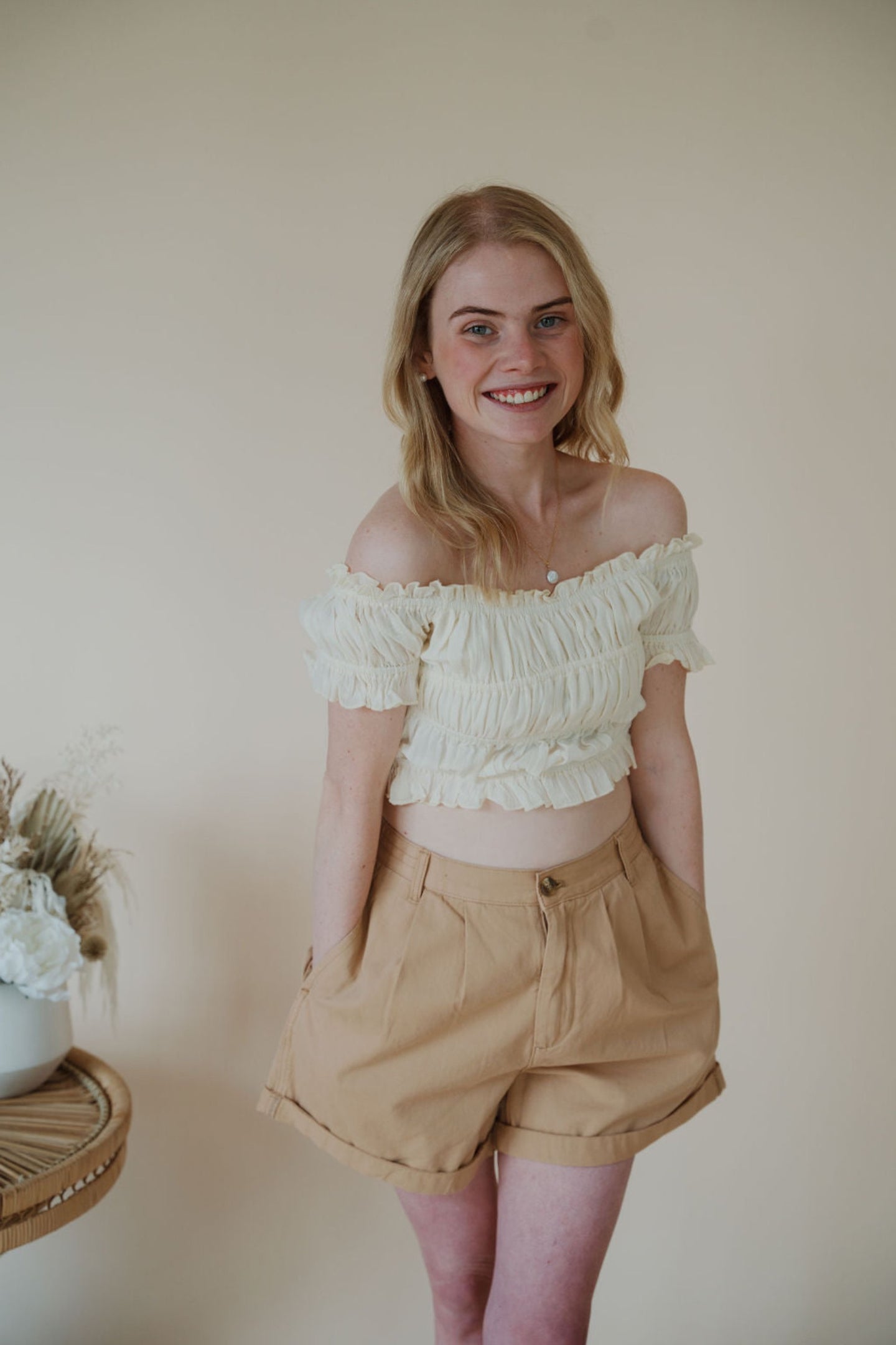 front view of model wearing the steady love top. model has the top paired with the sweetest melody shorts in the color khaki.