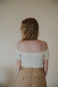 back view of model wearing the steady love top. model has the top paired with the sweetest melody shorts in the color khaki.