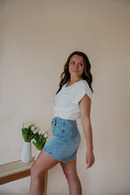 Load image into Gallery viewer, side view of model wearing the look after you sweater vest. model has the sweater vest paired with the austin denim shorts.