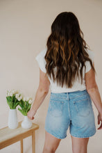 Load image into Gallery viewer, back view of model wearing the austin denim shorts. model has the shorts paired with the look after you sweater vest.