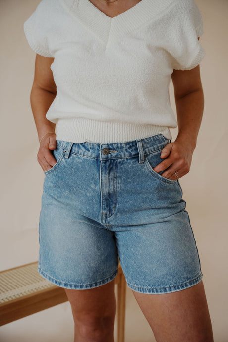 detail view of model wearing the austin denim shorts. model has the shorts paired with the look after you sweater vest.