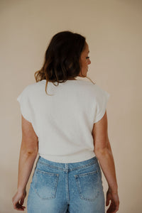 back view of model wearing the look after you sweater vest. model has the sweater vest paired with the austin denim shorts.