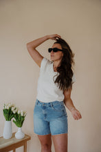 Load image into Gallery viewer, front view of model wearing the look after you sweater vest. model has the sweater vest paired with the austin denim shorts and the onyx sunglasses in the color black.