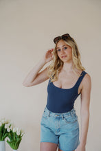 Load image into Gallery viewer, front view of model wearing the dakota denim shorts. model has the shorts paired with the used to know bodysuit in the color navy and the dainty mallory necklace.