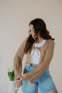 front view of model wearing the ocean avenue cardigan in the color taupe. model has the cardigan paired with the forever yours top in the color white and the austin denim shorts.