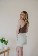Load image into Gallery viewer, back side view of model wearing the parker denim shorts. model has the shorts paired with the change your mind bodysuit in the color walnut and the dainty mallory necklace.