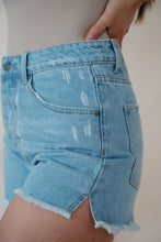 Load image into Gallery viewer, side detail view of model wearing the boston denim shorts. model has the shorts paired with the used to know bodysuit in the color biscuit.