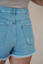 Load image into Gallery viewer, close back  view of model wearing the boston denim shorts. model has the shorts paired with the used to know bodysuit in the color biscuit.