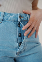 Load image into Gallery viewer, detail view of model wearing the boston denim shorts. model has the shorts paired with the used to know bodysuit in the color biscuit.