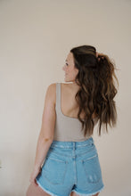 Load image into Gallery viewer, back view of model wearing the used to know bodysuit in the color biscuit. model has the top paired with the boston denim shorts and the anna necklace.