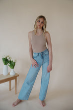 Load image into Gallery viewer, front view of model wearing the genevive denim. model has the denim paired with the change your mind bodysuit in the color light sand and the dainty mallory necklace.