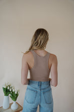 Load image into Gallery viewer, back view of model wearing the change your mind bodysuit in the color light sand. model has the top paired with the genevieve denim and the dainty mallory necklace.