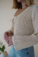 Load image into Gallery viewer, detail view of model wearing the ocean avenue cardigan in the color cream. model has the cardigan paired with the forever yours top in the color macchiato and the austin denim shorts.
