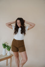 Load image into Gallery viewer, front view of model wearing the hayden denim shorts. model has the shorts paired with the take a chance bodysuit in the color off white and the anna necklace.