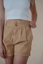 Load image into Gallery viewer, front detail view of model wearing the sweetest melody shorts in the color khaki. model has the shorts paired with the last to know top in the color white.