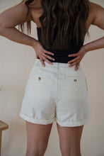 Load image into Gallery viewer, back detail view of model wearing the sweetest melody shorts in the color cream. model has the shorts paired with the last to know top in the color black.