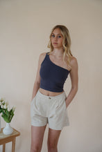 Load image into Gallery viewer, front view of model wearing the making promises shorts. model has the shorts paired with the last to know top in the color asphalt grey.