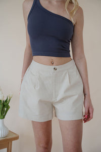 front detail view of model wearing the making promises shorts. model has the shorts paired with the last to know top in the color asphalt grey.