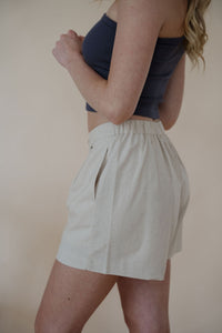 side detail view of model wearing the making promises shorts. model has the shorts paired with the last to know top in the color asphalt grey.