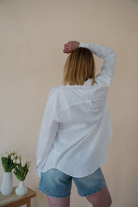 back view of model wearing the ordinary love top. model has the top paired with the austin denim shorts.
