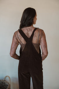 back view of model wearing the settlin' down corduroy overalls in the color brown. model has the overalls paired with the here to stay top in the color brown.