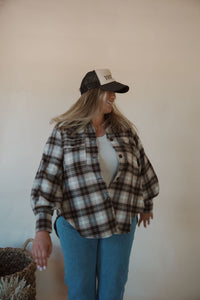 front view of model wearing the yeehaw trucker hat. model has the hat paired with the something's changed shacket and the forever yours tank in the color light beige.