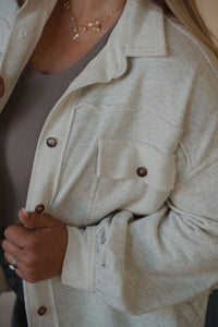 detail view of model wearing the never be the same shacket. model has the shacket paired with the change your mind bodysuit in the color smoky taupe.